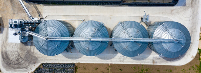 Aerial top view of modern agricultural Silo. Set of storage tanks cultivated agricultural crops processing plant. © EdVal