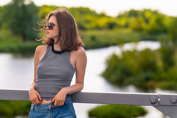 Girl looks away while standing on the bridge