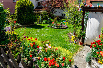 Fototapeta na wymiar Private garden of a house with colorful flowers