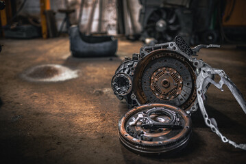 Gearbox, clutch and flywheel on the floor in the garage indergoing repar.