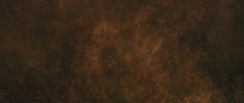 Slow-motion shot of floating dust particles in the air. Dust in the room with dark background
