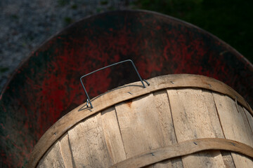 bushel basket with metal handle in a gardening wheelbarrow - strobe light effect