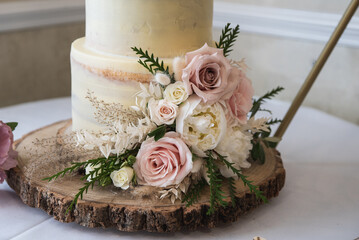 A traditional white wedding cake with floral decoration