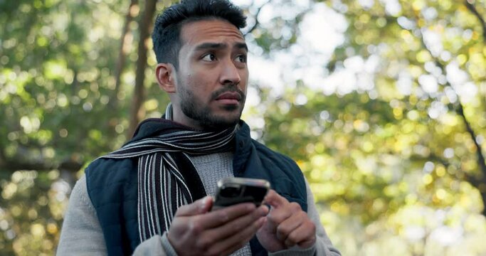 Man, hiking and smartphone, lost and navigation with digital map, nature walk in forest during winter and travel. Adventure, trekking and search location, male person using phone and direction on app