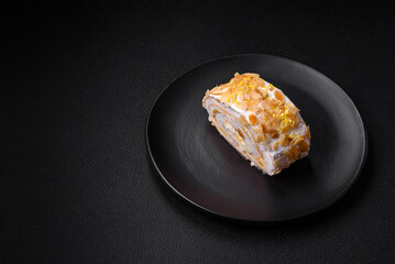 Delicious, fresh, sweet meringue roll with cream, almond chips, nuts and berries