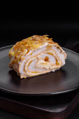 Delicious, fresh, sweet meringue roll with cream, almond chips, nuts and berries