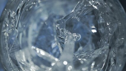 Super Slow Motion Detail Shot of Pouring Vodka on Crystal Clear Ice Cubes at 1000 fps.