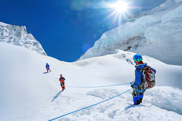 Climber reaches the summit of mountain peak enjoying the landscape view. Nepal, Everest region