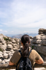 Fototapeta premium Woman looking at limestone rock formations in El Torcal de Antequera nature reserve, in Spain