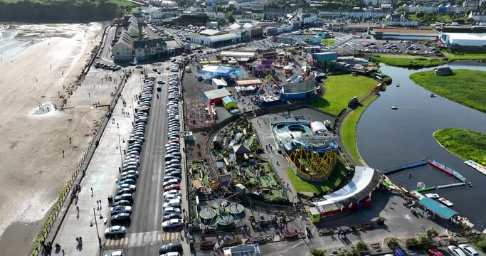 An aerial view of the amusement park against the backdrop of Tramore, Ireland 4k