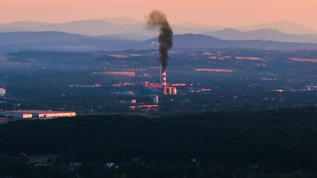 Top aerial view of a working coal burning power plant at an industrial zone. Industrial landscape, the pipes of the thermal power plant. Dense smoke in power station industrial chimneys.