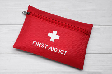 Medicine bag on white wooden table, top view. First aid kit
