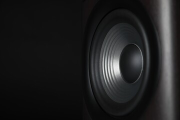 One sound speaker on black background, closeup. Space for text