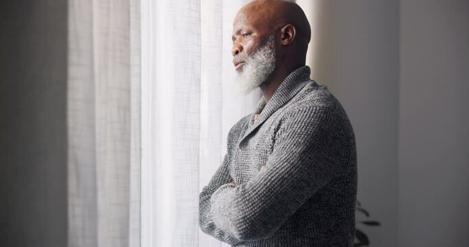 Depressed, sad and senior man in home with mourning and memory with mental health problem. African male person, sorry and anxiety in a house feeling disappointed in retirement with grief by window