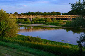 Fototapeta premium View on Pont de Pouilly-sur-Loire bridge 496 km from the source and 496 km from the mouth of the Loire river near Pouilly-sur-loire, Central France ar sunset