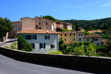 Travel destination, small ancient village Cotignac in Var, Provence, surrounded by vineyards and cliffs with troglodytes houses.