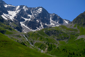 Mountains and alpine meadows views near Col du Lautaret, Massif des Ecrins, Hautes Alpes, France in summer