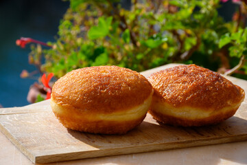Fried in oil french stuffed with apples or chocolate beignets donuts pastry, sweet dessert served outdoor