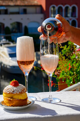 Summer party, drinking of French brut rose champagne sparkling wine in glasses in yacht harbour of Port Grimaud near Saint-Tropez, French Riviera vacation, France