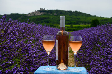 Summer in French Provence, cold gris rose wine from Cotes de Provence and blossoming colorful lavender fields on Valensole plateau, tastes and aromas Provence, France - obrazy, fototapety, plakaty