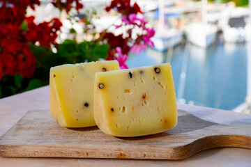 Cheese collection, Italian aged pecorino cheese with black peppers made in region Nebrodi, Sicily, Italy, close up