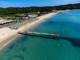 Crystal clear blue water of legendary Pampelonne beach near Saint-Tropez, summer vacation on white sandy beach of French Riviera, France