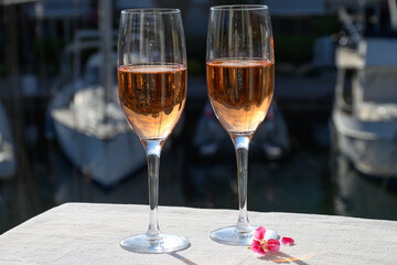 Summer party, drinking of French brut rose champagne sparkling wine in glasses in yacht harbour of Port Grimaud near Saint-Tropez, French Riviera vacation, France