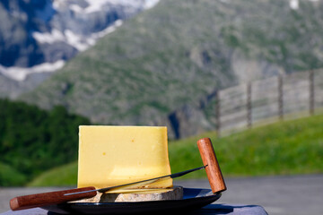 Cheese collection, French cow cheese comte, beaufort, abondance and french mountains village in summer in Haute-Savoie on background