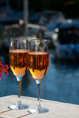 Summer party, drinking of French brut rose champagne sparkling wine in glasses in yacht harbour of Port Grimaud near Saint-Tropez, French Riviera vacation, France
