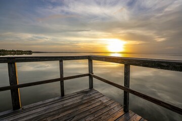 Fototapeta na wymiar Dreamy sunset view from the fishing pier at Newton Park in Winter Garden, Florida