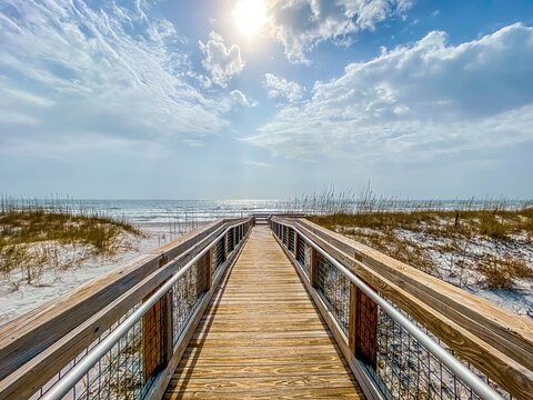 Sun shining bright over boardwalk at Pensacola Beach in Florida