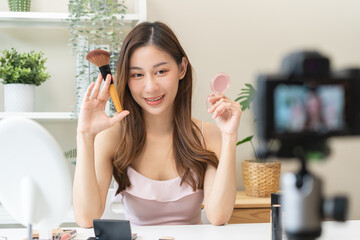 Beauty blogger, asian young woman, girl vlogger makeup face, showing, reviews cosmetics products...