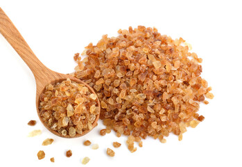 Brown rock sugars in wooden spoon isolated on white background