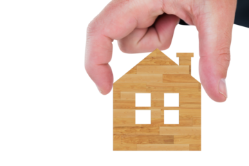 Digital png photo of hand with wooden model of house on transparent background