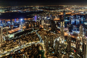 Fototapeta na wymiar Night view from the observation deck of the tallest building in the world - Burj Khalifa illuminated by lights the Dubai city, United Arab Emirates