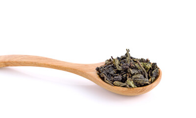 Dry Chinese tea leaves on wooden spoon on white background