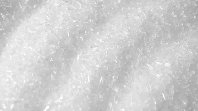 Macro video of MSG showcases its microscopic crystals, revealing the flavor-enhancing magic. As it dissolves, the umami essence bursts, captivating taste buds worldwide. 
