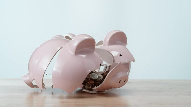 Piggy bank falling and breaking in super slow motion