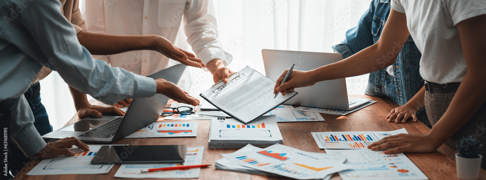 Aufkleber Analyst team utilizing BI Fintech to analyze and pointing at financial dashboard paper office. Businesspeople examining report paper on table for business insight. Panorama shot. Scrutinize