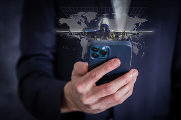 Hand using mobile phone checking Trip Destination online at airport.