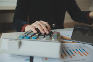 Unrecognizable businessman using calculator