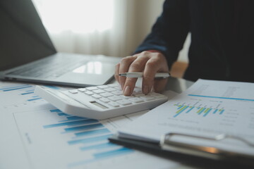 Unrecognizable businessman using calculator