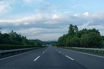 Fototapeta premium highway road and green forest with mountain nature landscape