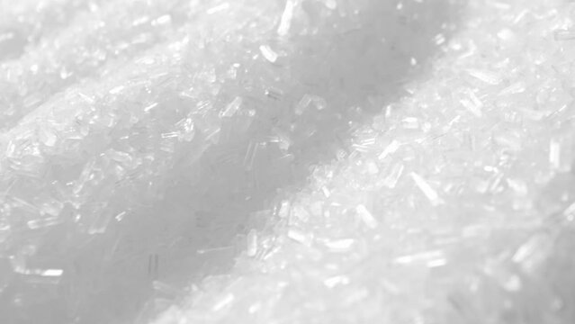 Macro video of MSG, a flavor enhancer commonly used in foods. Crystalline texture and reveals its ability to dissolve quickly, releasing the umami taste that enhances savory dishes.
