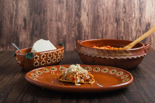 Authentic mexican chicken tinga with fresh cheese and cream on toast.