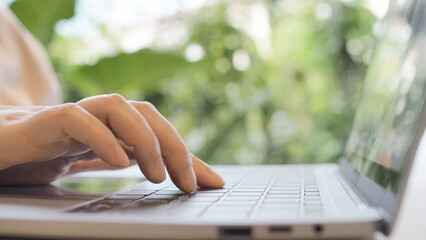 Using computer at work, typing on keyboard on the office desk
