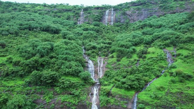 Aerial footage of a monsoon season waterfall near Pune India. Monsoon is the annual rainy season in India from June to September.