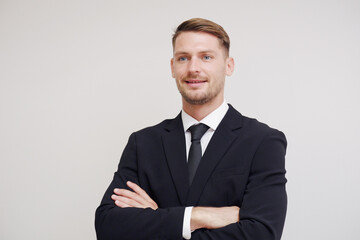 Young smiling businessman in suit on white background.