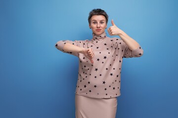 doubtful well-groomed young careerist woman with gray streaked hair dressed in a skirt and blouse...