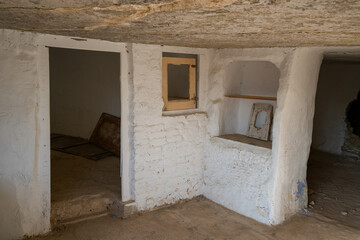 Argueda caves abandoned interior with decoration details and white walls,in Spain